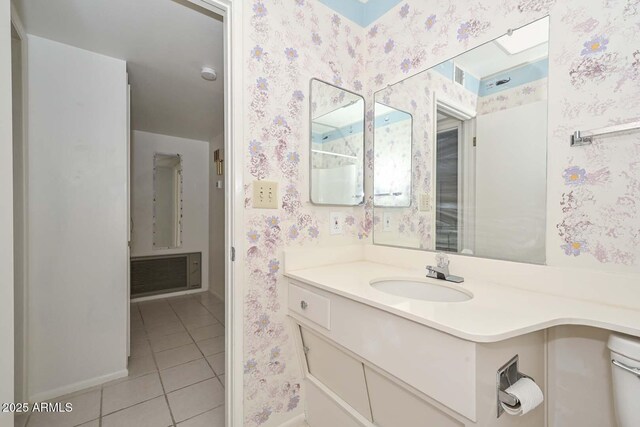 bathroom with visible vents, toilet, wallpapered walls, tile patterned flooring, and vanity