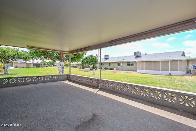 view of patio with central AC unit and a sunroom