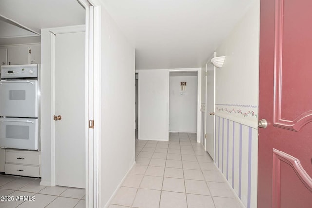 hall with light tile patterned floors