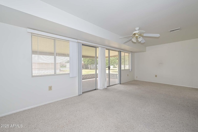 spare room featuring visible vents, carpet, and a ceiling fan