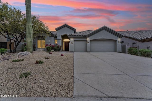 16615 N 109th Pl, Scottsdale, AZ 85255 - mediterranean / spanish home with an attached garage, a tile roof, stucco siding, and concrete driveway
