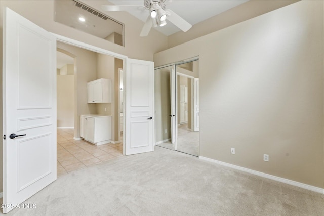 16615 N 109th Pl, Scottsdale, AZ 85255 - unfurnished bedroom featuring a closet, arched walkways, light colored carpet, baseboards, and visible vents