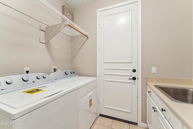 16615 N 109th Pl, Scottsdale, AZ 85255 - clothes washing area featuring washing machine and dryer, a sink, light tile patterned floors, and cabinet space