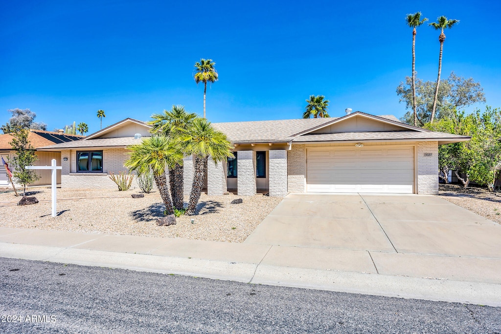 ranch-style home featuring a garage