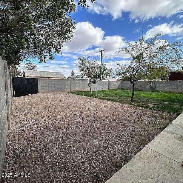 view of yard with a fenced backyard