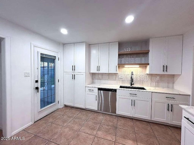 kitchen with a sink, backsplash, dishwasher, light countertops, and open shelves