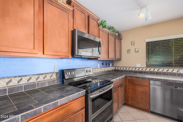 kitchen featuring light tile patterned floors and appliances with stainless steel finishes