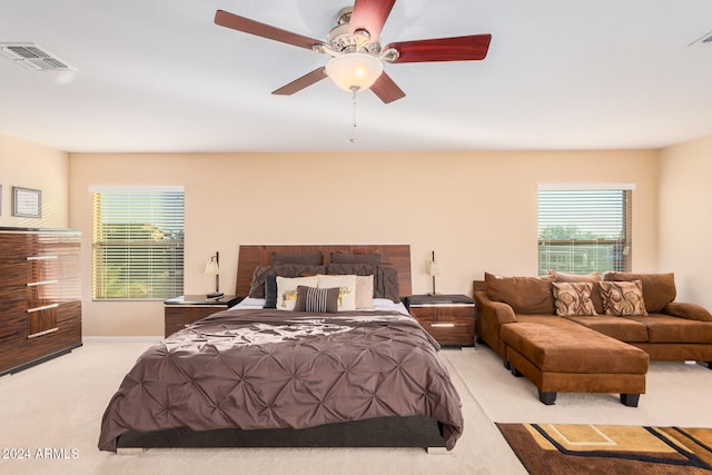 bedroom with light carpet and ceiling fan