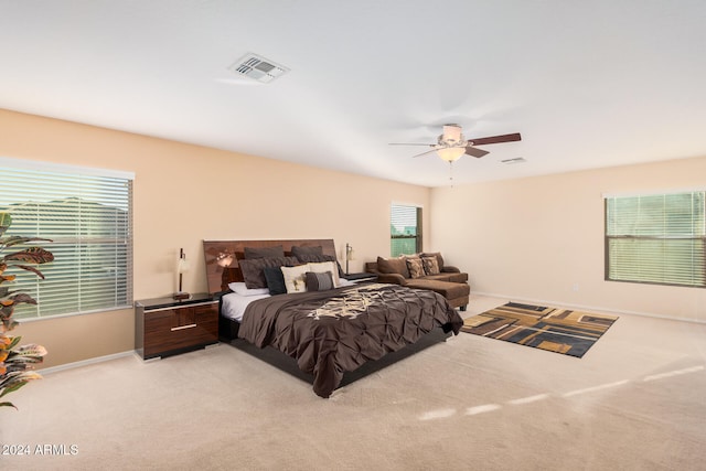 bedroom with light carpet and ceiling fan