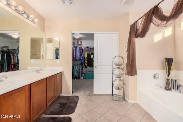 bathroom featuring a bathtub, vanity, and tile patterned floors