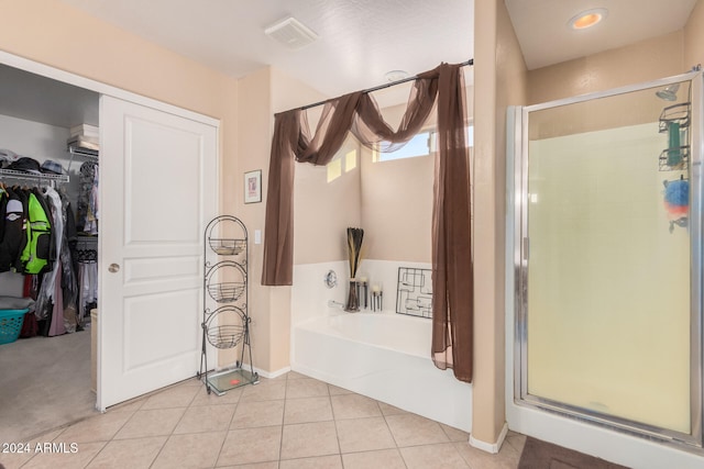 bathroom featuring tile patterned flooring and plus walk in shower