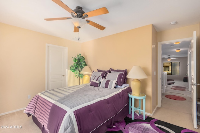 bedroom featuring light colored carpet and ceiling fan