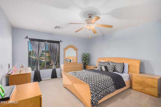 bedroom featuring light colored carpet and ceiling fan