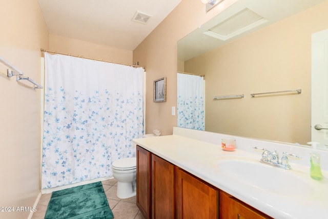 bathroom with toilet, vanity, tile patterned flooring, and walk in shower