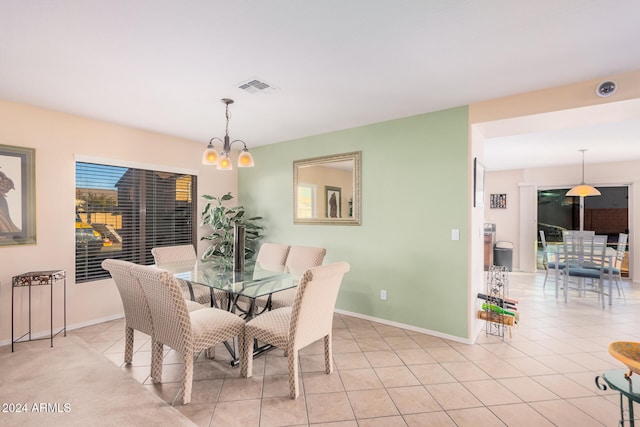 tiled dining area featuring a notable chandelier