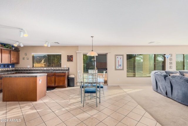 kitchen featuring hanging light fixtures, track lighting, and light tile patterned floors