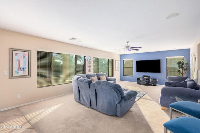 tiled living room with ceiling fan