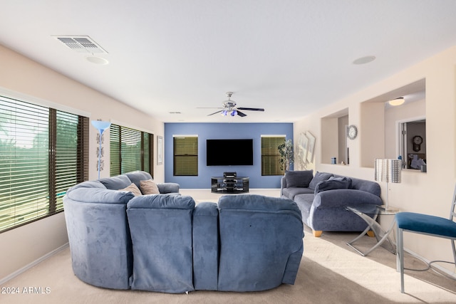 carpeted living room with ceiling fan and plenty of natural light