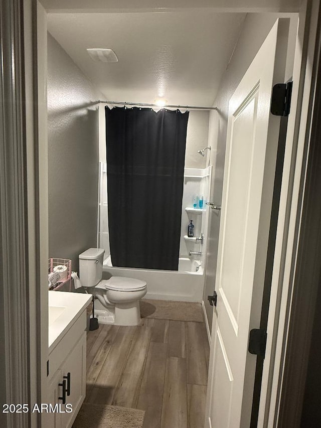 1418 E Jacqueline Pl, Casa Grande, AZ 85122 - bathroom featuring toilet, wood finished floors, vanity, and shower / bath combo