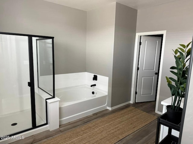 1418 E Jacqueline Pl, Casa Grande, AZ 85122 - bathroom featuring wood finished floors, a bath, baseboards, and a stall shower