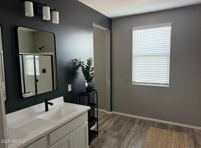 1418 E Jacqueline Pl, Casa Grande, AZ 85122 - bathroom with wood finished floors, vanity, and baseboards