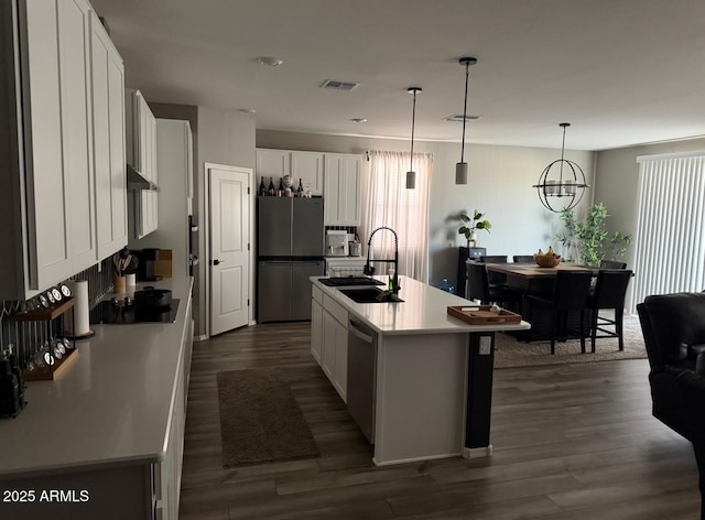 1418 E Jacqueline Pl, Casa Grande, AZ 85122 - kitchen featuring stainless steel appliances, a sink, dark wood-type flooring, white cabinets, and hanging light fixtures