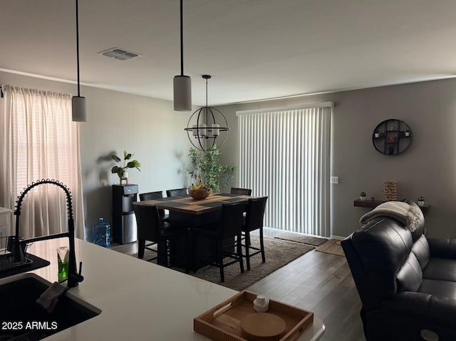 1418 E Jacqueline Pl, Casa Grande, AZ 85122 - dining area with wood finished floors, a chandelier, and baseboards