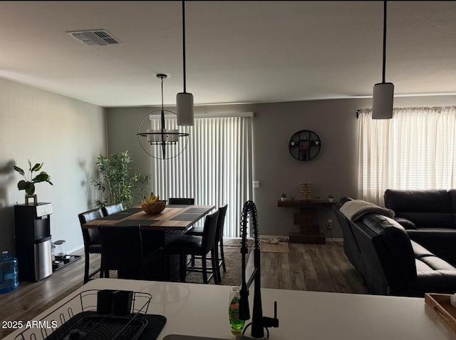 1418 E Jacqueline Pl, Casa Grande, AZ 85122 - dining area with a chandelier, wood finished floors, and baseboards
