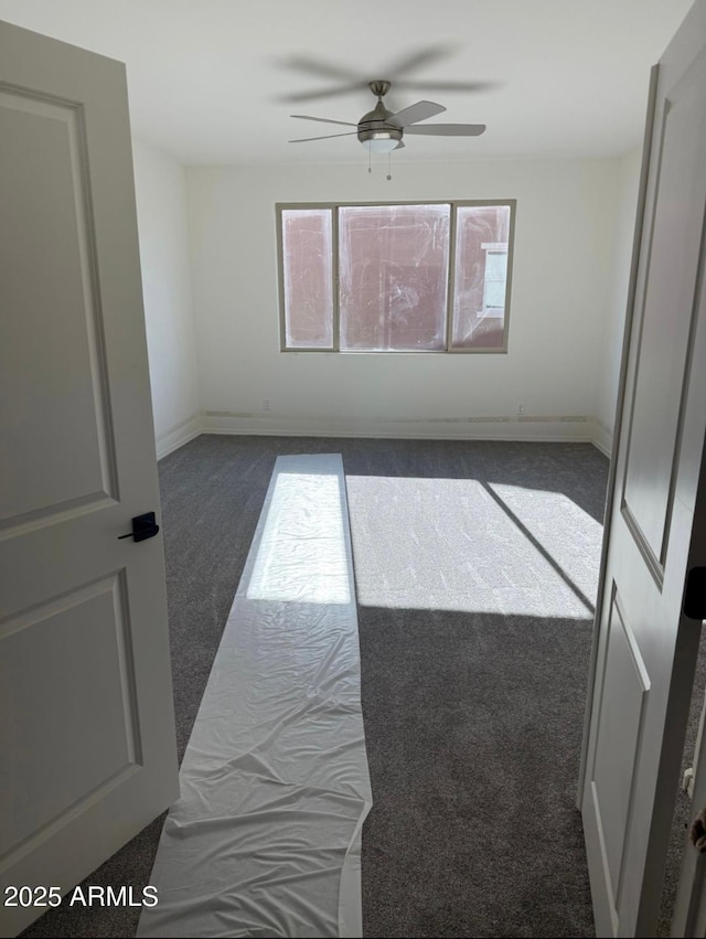 1418 E Jacqueline Pl, Casa Grande, AZ 85122 - empty room featuring ceiling fan, dark carpet, and baseboards