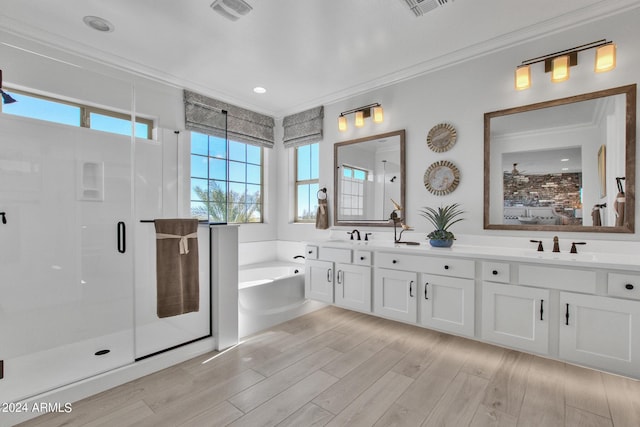 bathroom with independent shower and bath, crown molding, hardwood / wood-style floors, and a healthy amount of sunlight