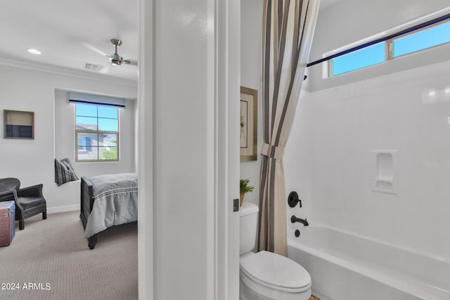 bathroom with ceiling fan, ornamental molding, shower / bath combo, and toilet