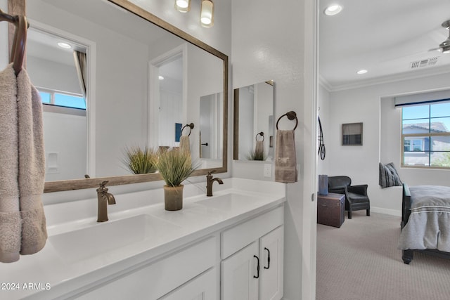 bathroom with vanity, a healthy amount of sunlight, and ornamental molding