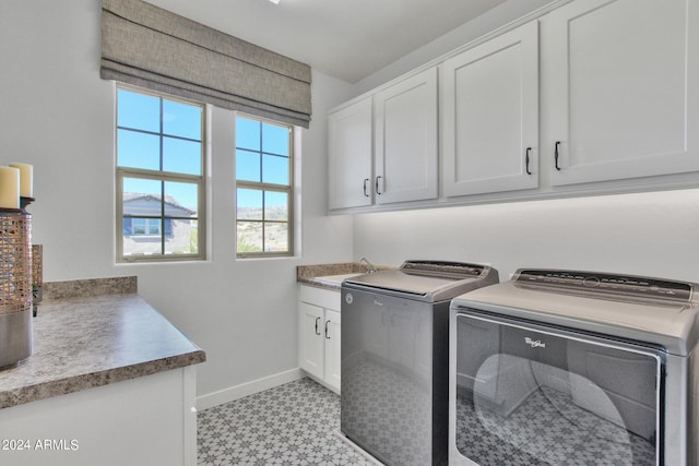 laundry room with cabinets, separate washer and dryer, and sink