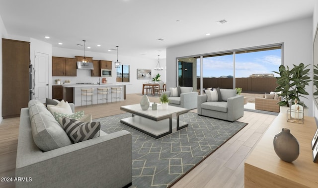 living area with plenty of natural light, visible vents, light wood-style floors, and recessed lighting