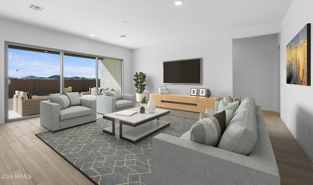 living area featuring visible vents, wood finished floors, and recessed lighting