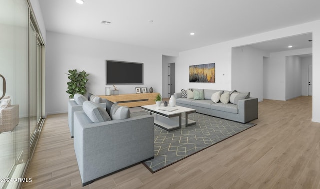 living area with recessed lighting, visible vents, and light wood-style floors