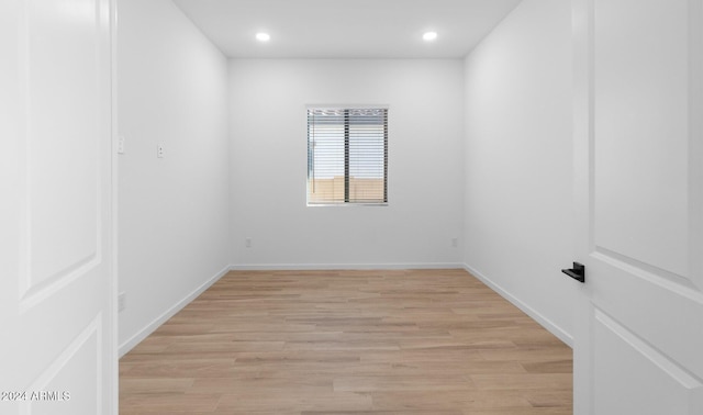 unfurnished room with baseboards, light wood-style flooring, and recessed lighting