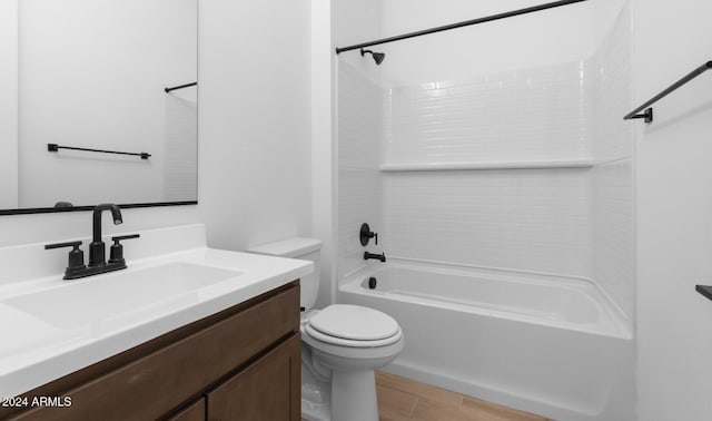 bathroom with washtub / shower combination, wood finished floors, toilet, and vanity