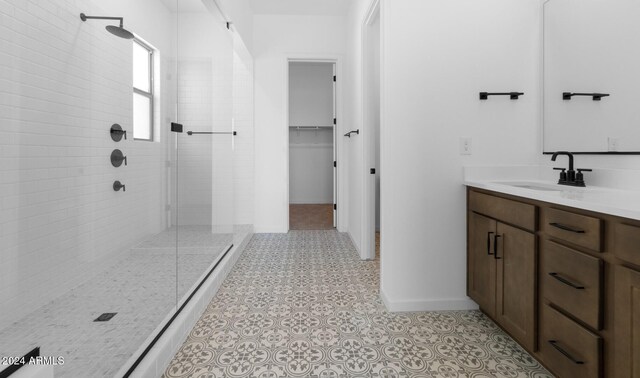 bathroom featuring vanity and a tile shower