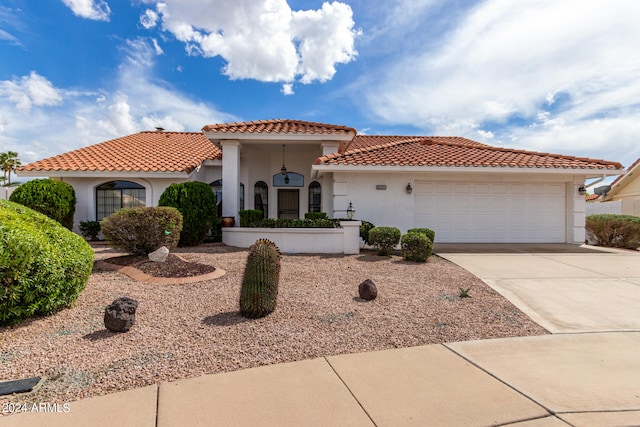 mediterranean / spanish house featuring a garage