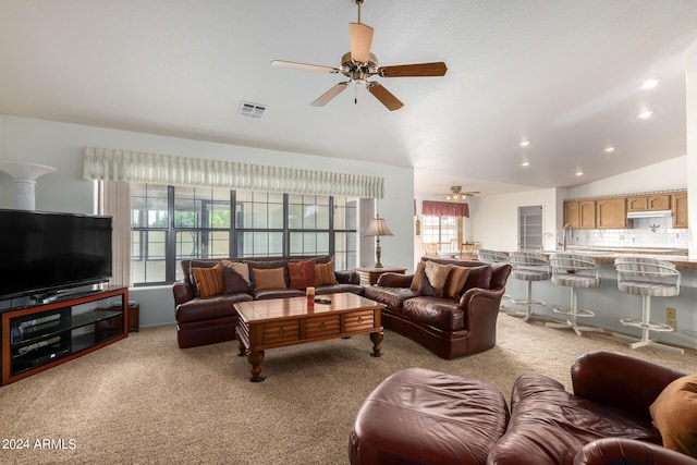 carpeted living room with lofted ceiling and ceiling fan