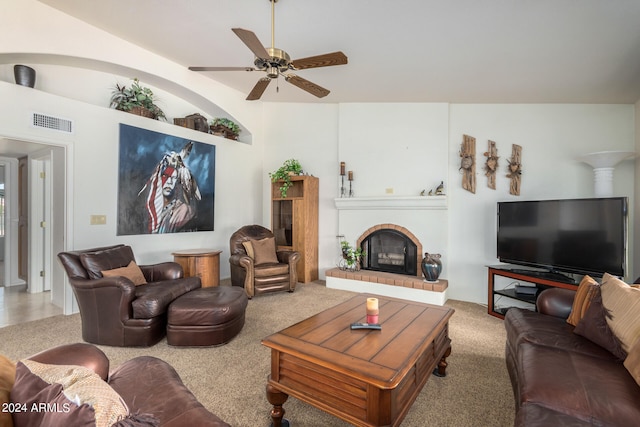 living room featuring lofted ceiling, ceiling fan, and a fireplace