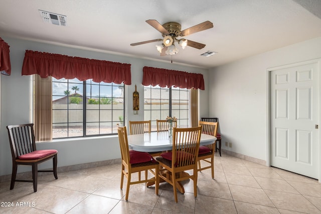 dining room featuring light tile floors and ceiling fan