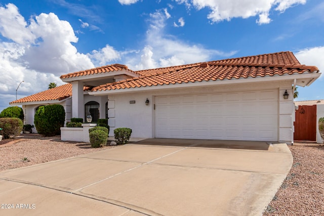 mediterranean / spanish house with a garage