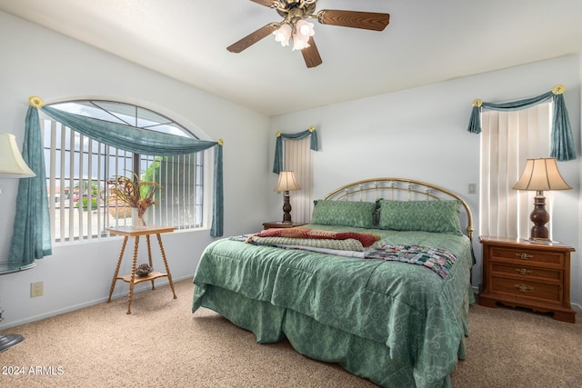 bedroom featuring ceiling fan and dark carpet