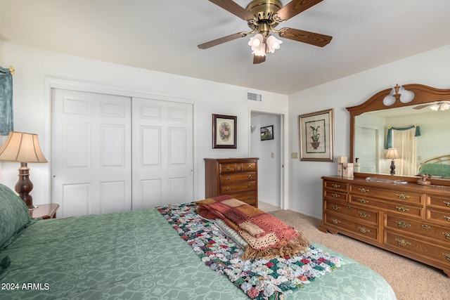 bedroom featuring a closet, ceiling fan, and light colored carpet