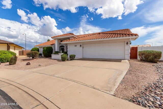 mediterranean / spanish-style home with a garage