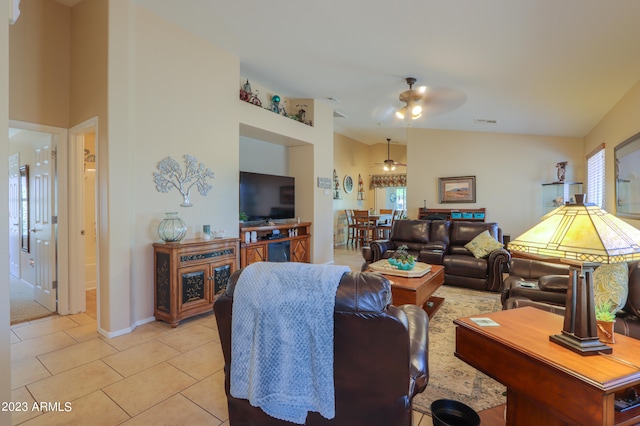 living room with lofted ceiling, light tile patterned floors, and ceiling fan