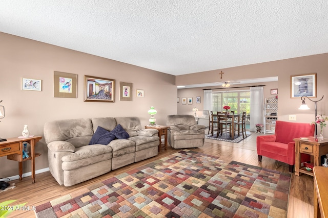 living room with a textured ceiling and wood-type flooring