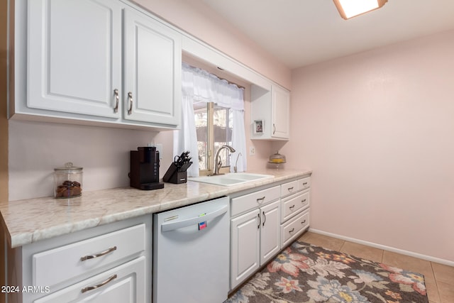 kitchen featuring white cabinetry, light tile patterned flooring, white dishwasher, and sink